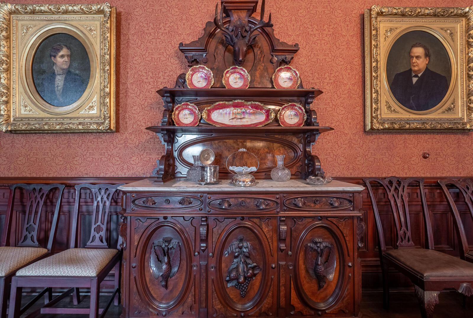 Side buffet table with portraits of Phineas and Mary Banning