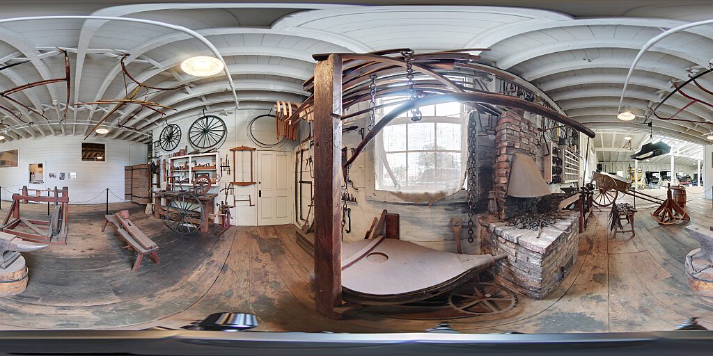 Panoramic view of blacksmith area with tools and benches.