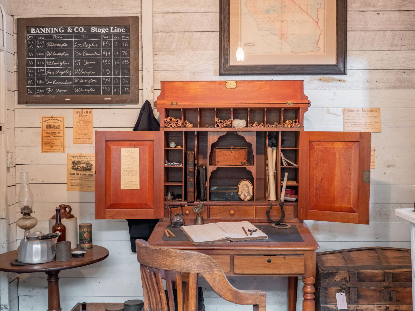 Stage Coach office wooden mailing desk with miscellaneous items including fountain pen, ink pot and mail