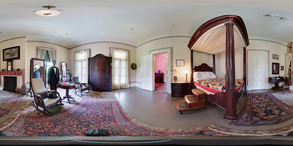 Panoramic view of entrance to Master Bedroom with four-poster canopy bed and steps.